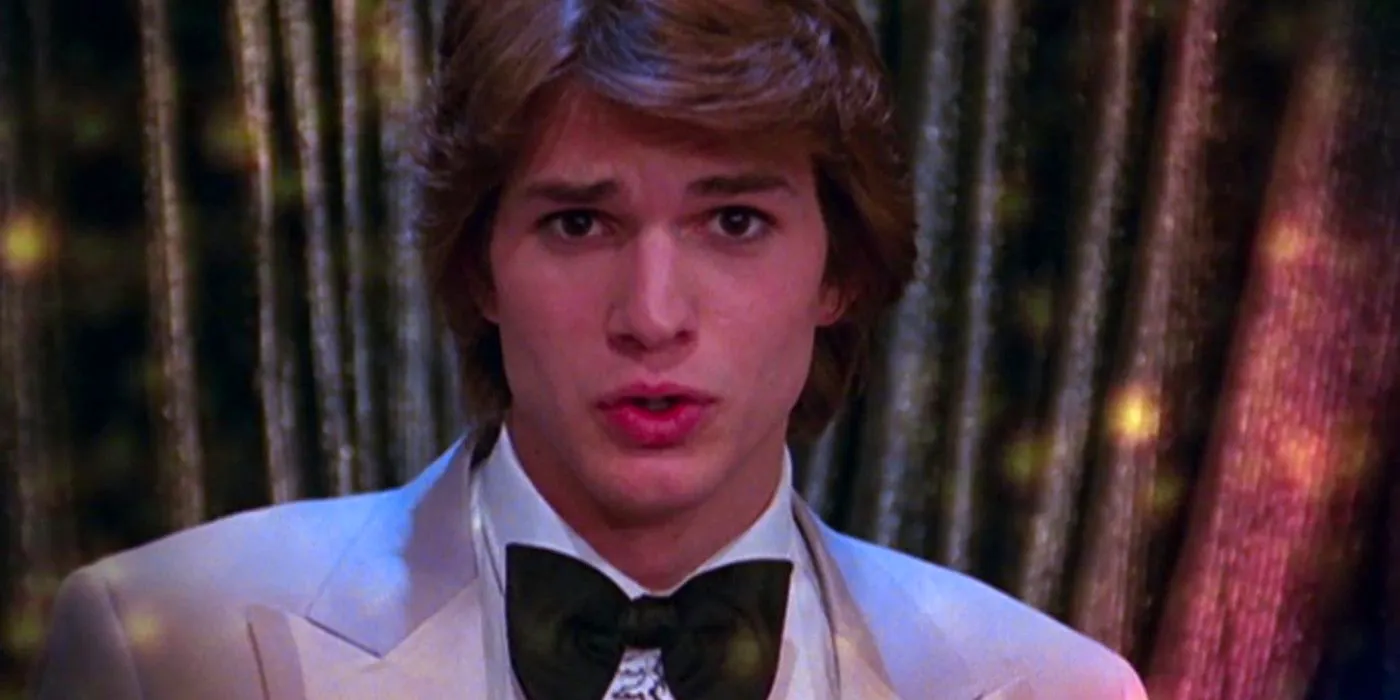 Ashton Kutcher as Michael Kelso in a suit and bow tie looking at the camera in That '70s Show musical Image