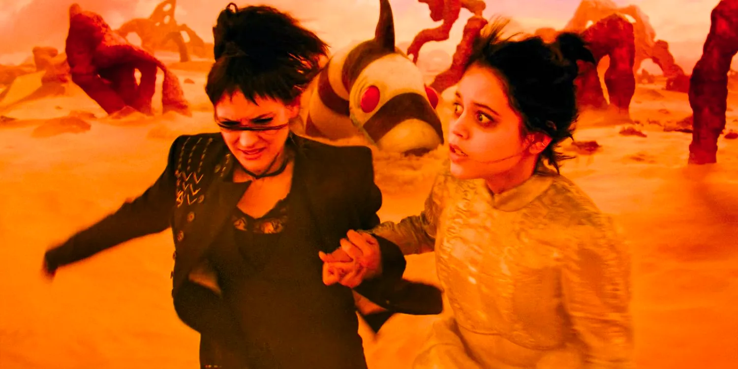 Astrid (Jenna Ortega) and Lydia Deetz (Winona Ryder) are running through the desert, trying to escape from a strange creature in Beetlejuice 2 Image