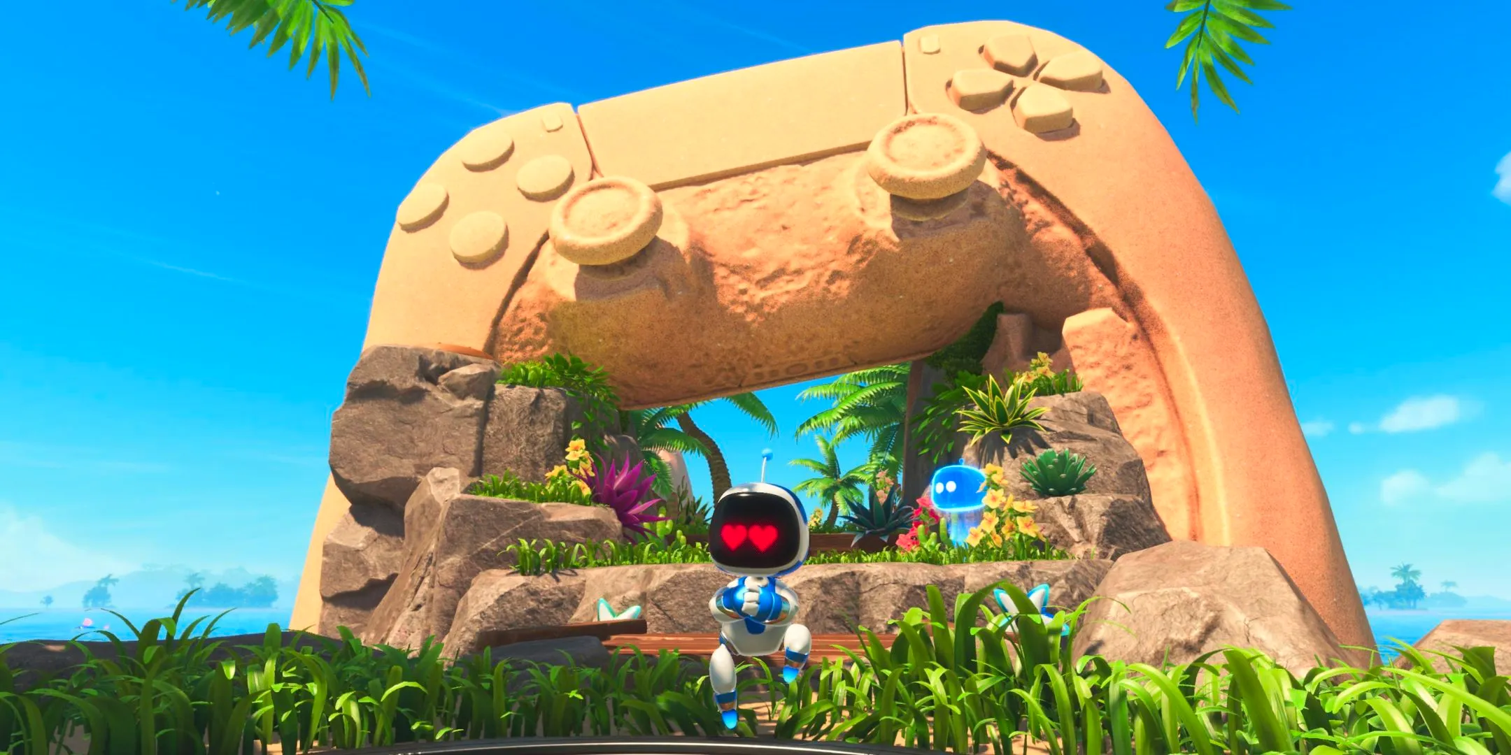 Astro Bot standing in front of a sand sculpture of a PS5 controller Image