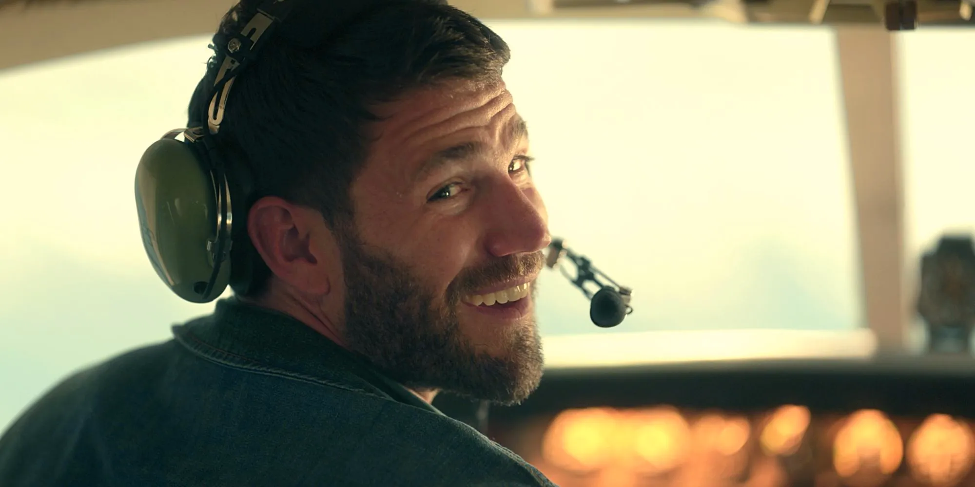 Austin Stowell as Sam in a plane with headset on in Season 1 Episode 1 of Keep Breathing Image