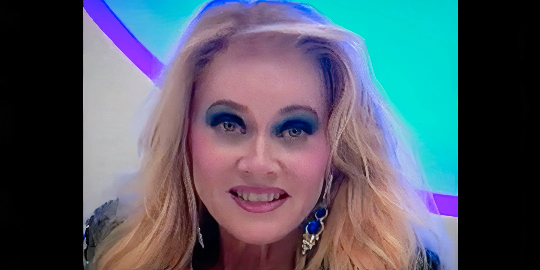 Barbara Crampton's Jacqueline smiling and looking directly at the camera in a promotional video in The Blue Diamond Image