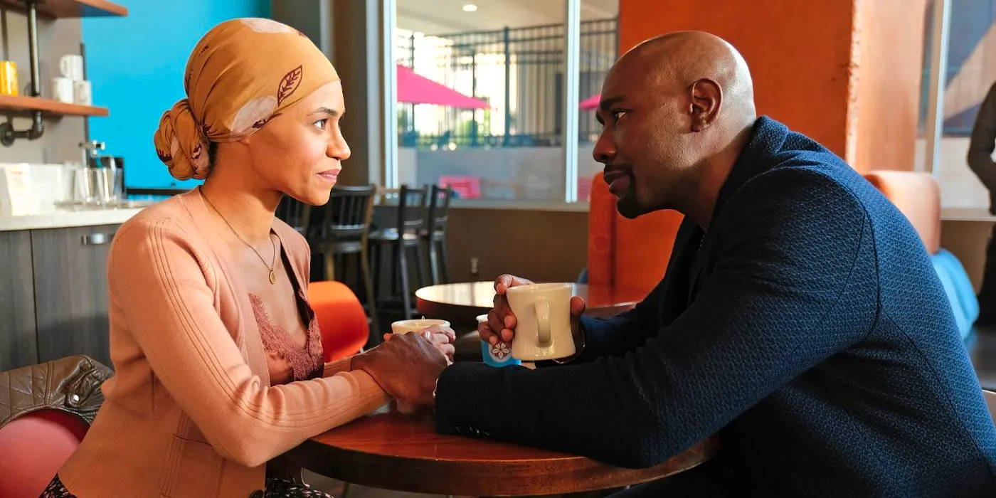 Barrett Cain (Morris Chestnut) holding Rose's (Cara Ricketts) hand as she smiles in The Resident. Image