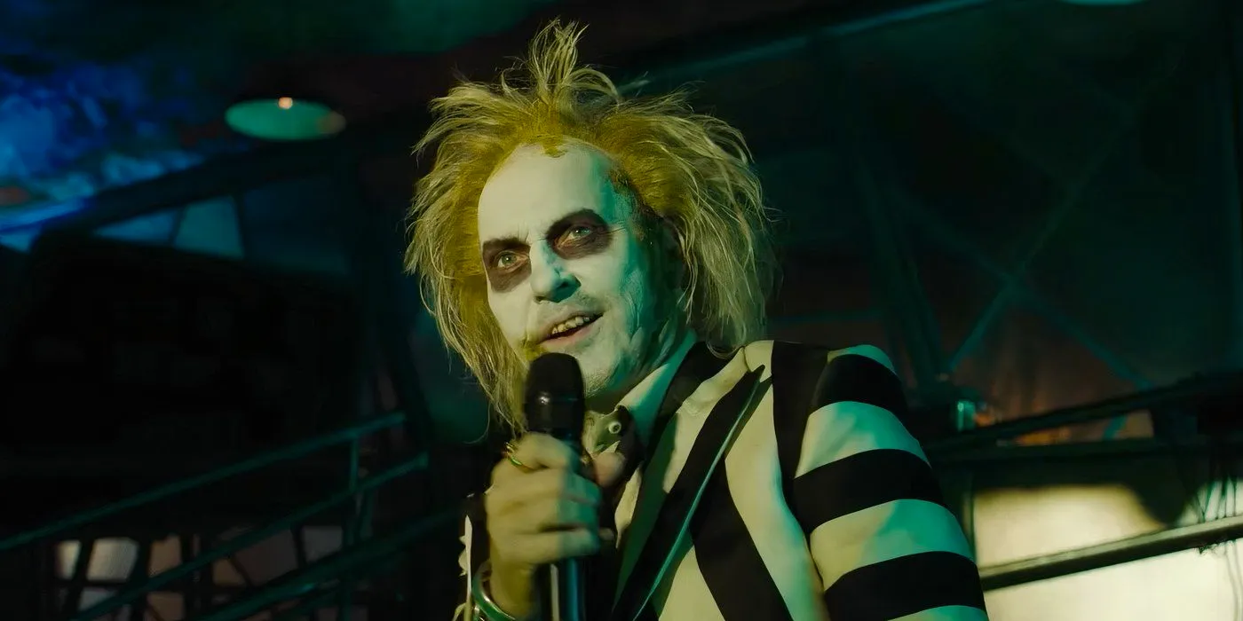 Betelgeuse talking into a microphone in Beetlejuice Beetlejuice Image