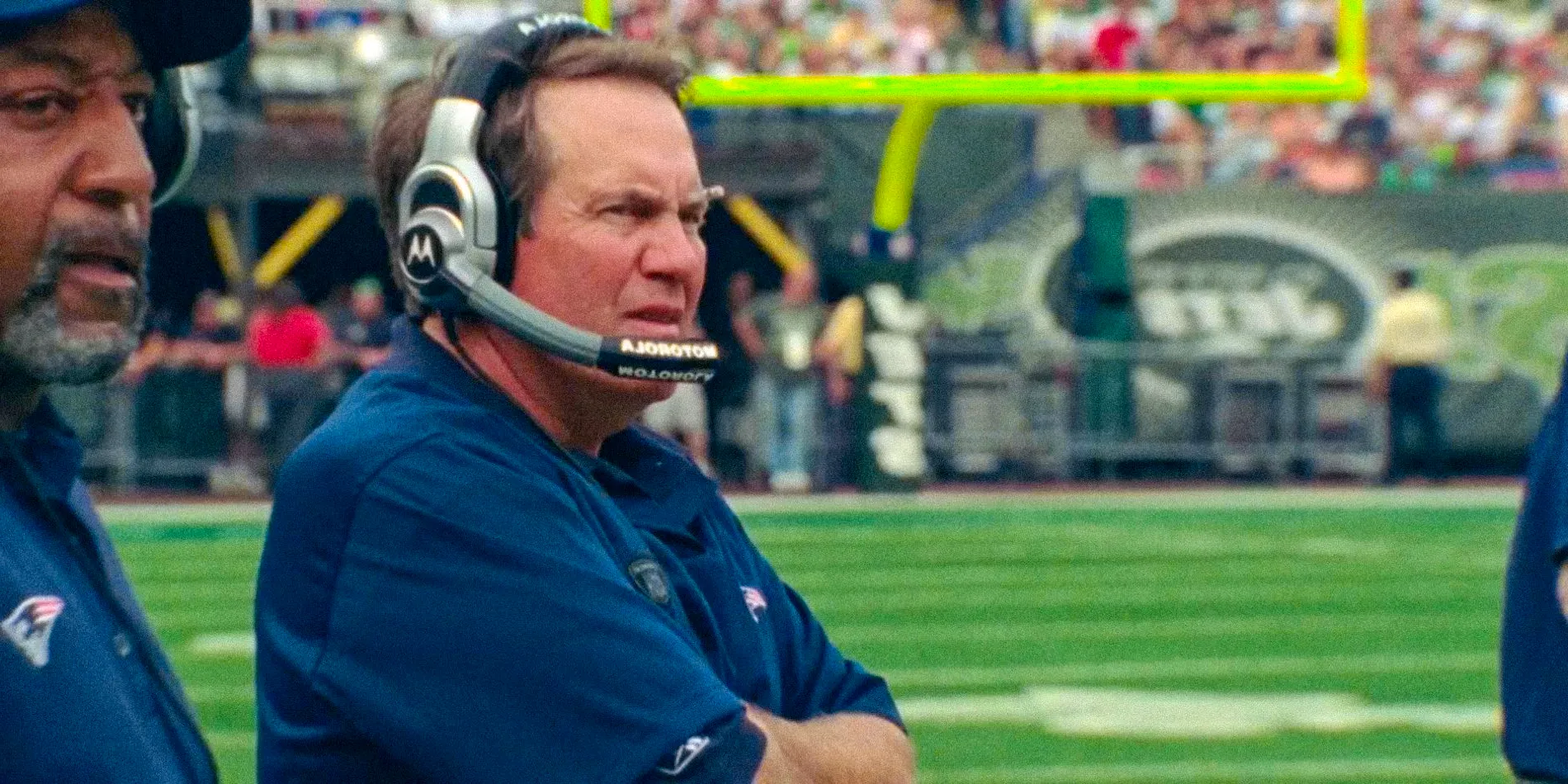 Bill Belichick looking worried at the field The Dynasty England Patriots Image