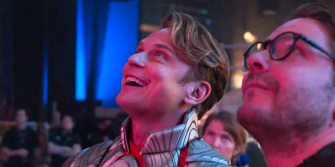 Billy Magnussen as Adam and Daniel Brühl as Eric looking up at something and smiling in The Franchise. Image