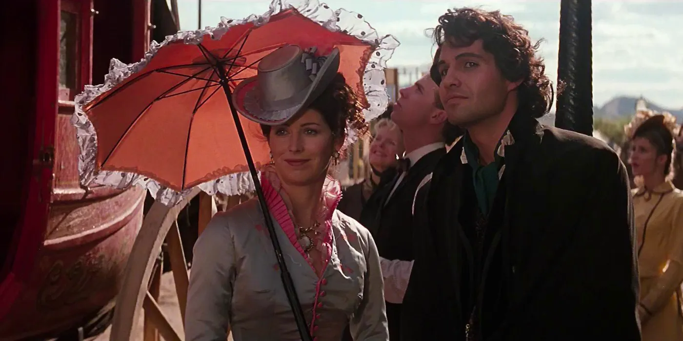 Billy Zane and Dana Delany smiling in the street in Tombstone Image