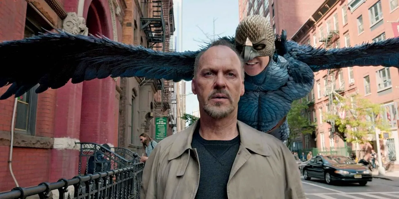 Birdman flies behind Michael Keaton as he walks down the street in Birdman Image