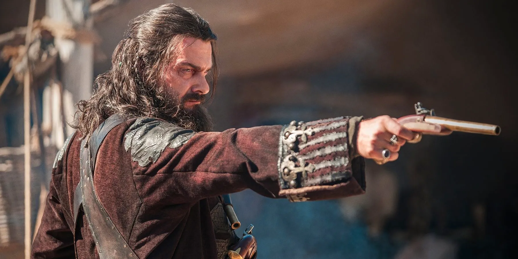 Blackbeard pointing a gun in Black Sails. Image