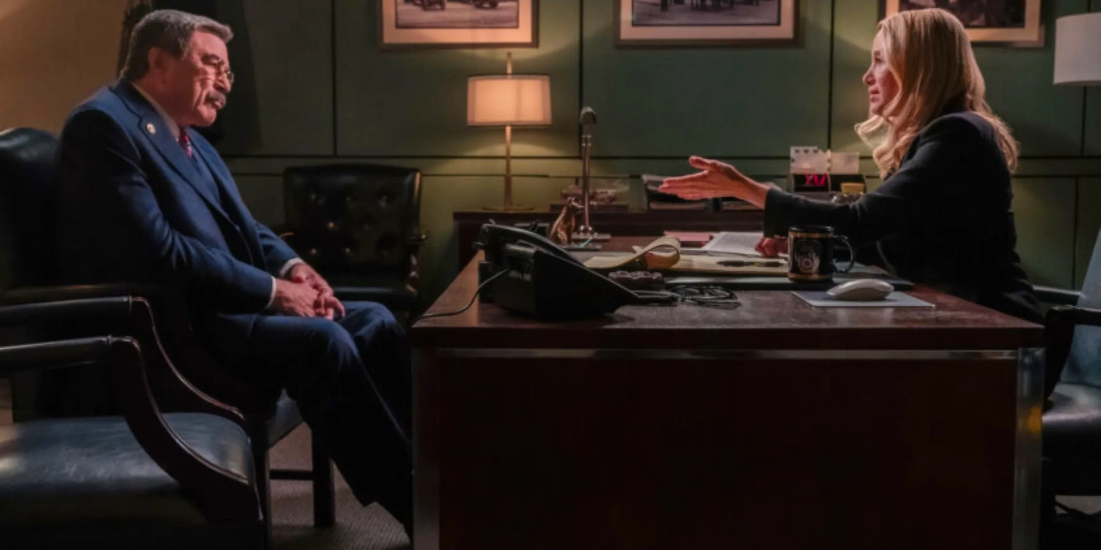 Blue Bloods Frank sitting across from the Fire Commissioner's desk looking irritated Image