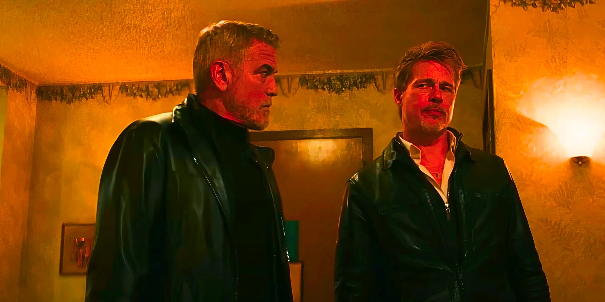 Brad Pitt and George Clooney looking annoyed with each other in Wolfs Image