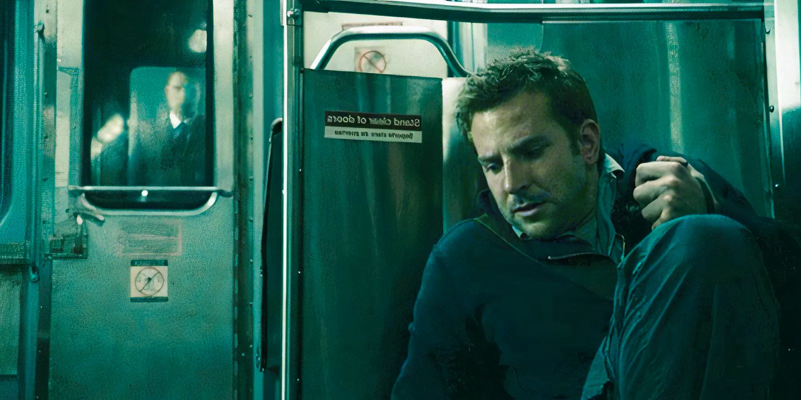 Bradley Cooper hiding behind a subway seat in The Midnight Meat Train Image