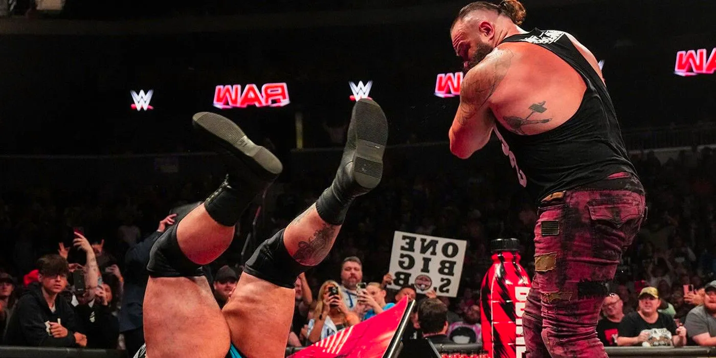 Braun Strowman chokeslams Bronson Reed through an announcer's table in WWE Monday Night Raw Image