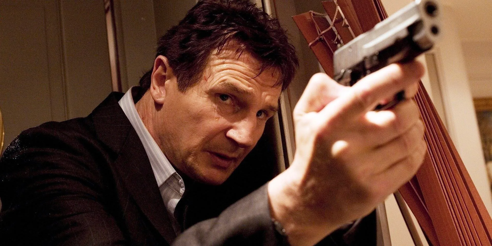 Bryan Mills with a gun in Taken Image