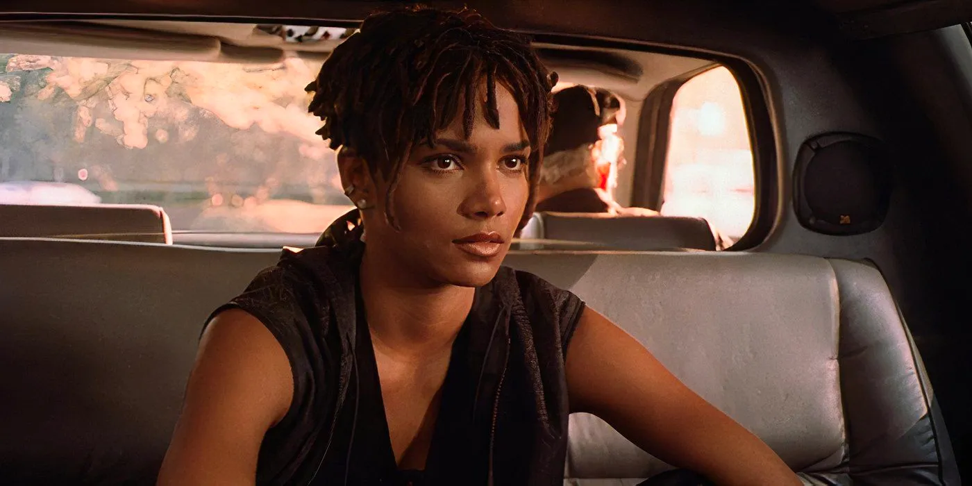 Bulworth Halle Berry as Nina sitting in the back of a limo in a black outfit Image