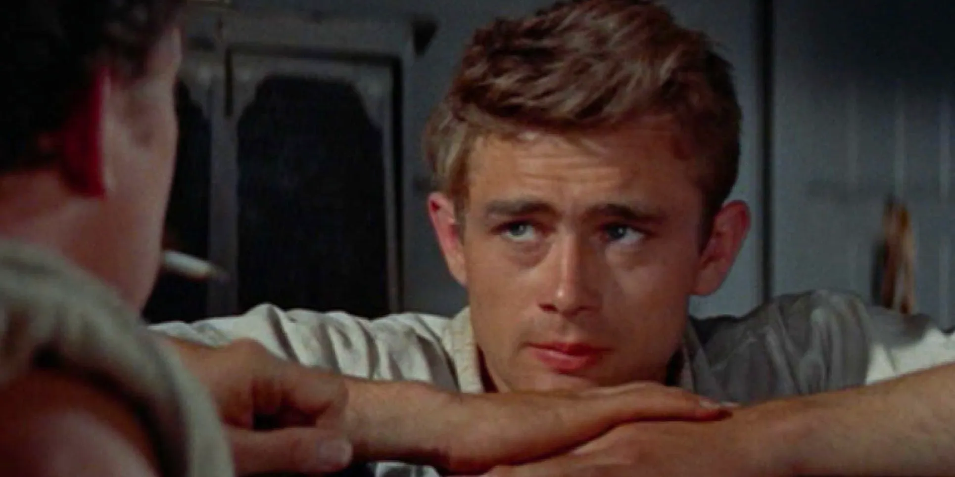 Cal Trask (James Dean) resting his chin on his folded hands Image