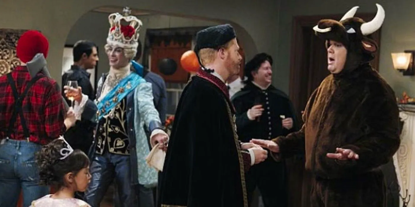 Cam and Mitchell dressed in costumes at a Halloween party on Modern Family Image