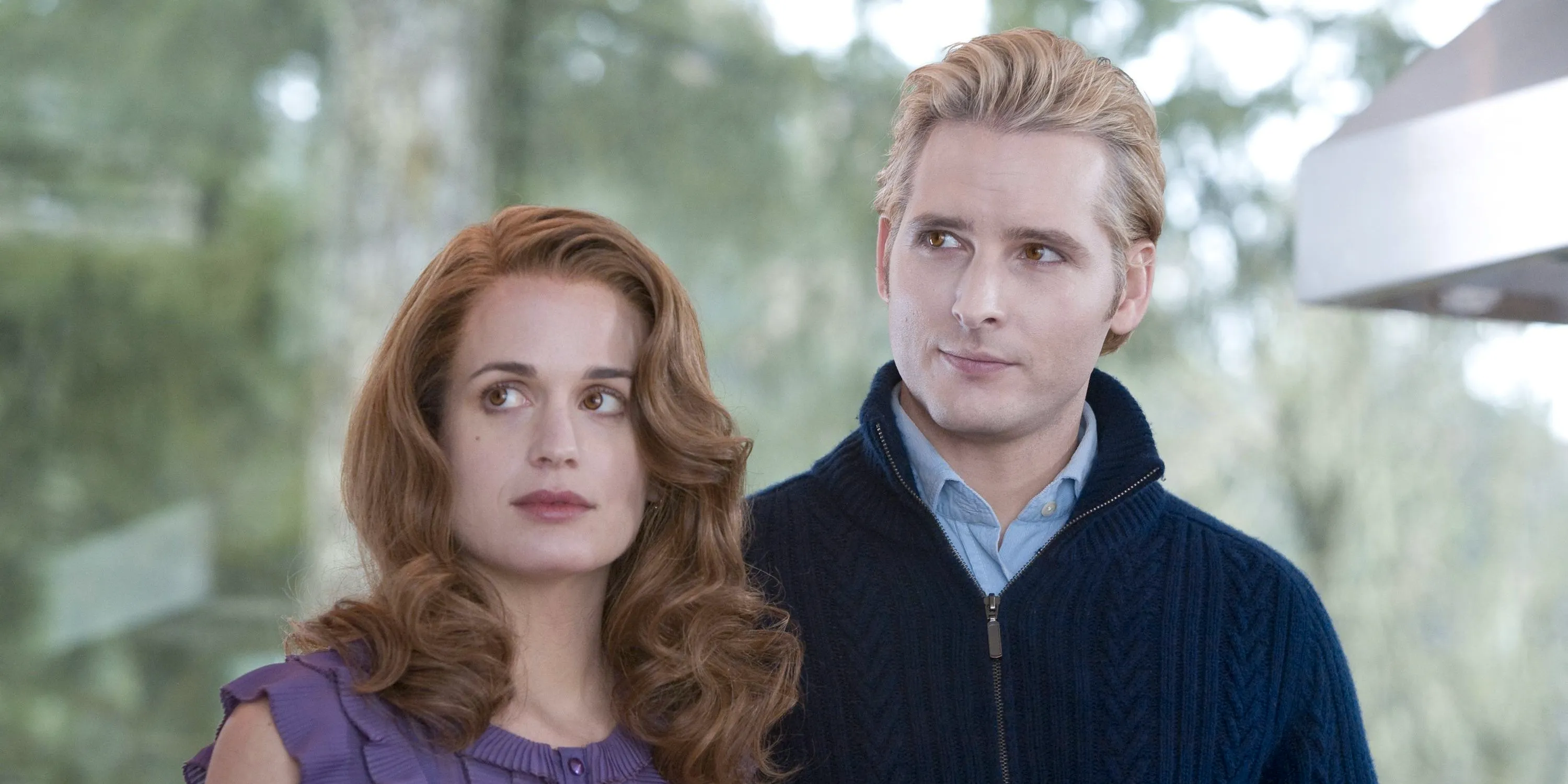 Carlisle and Esme standing next to each other in their home in The Twilight Saga Image