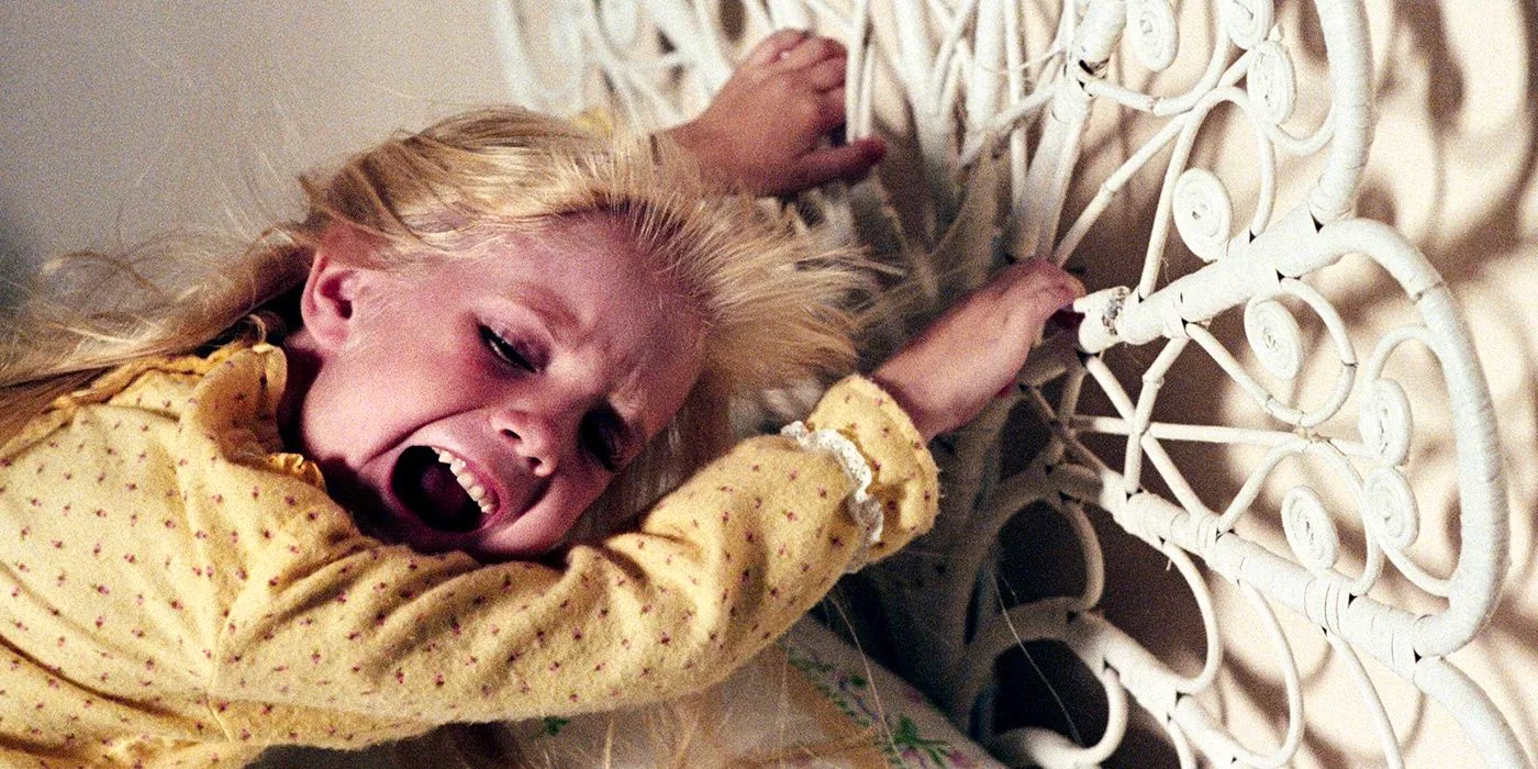 Carol Anne (Heather O'Rourke) holding onto her bed frame in Poltergeist 1982. Image