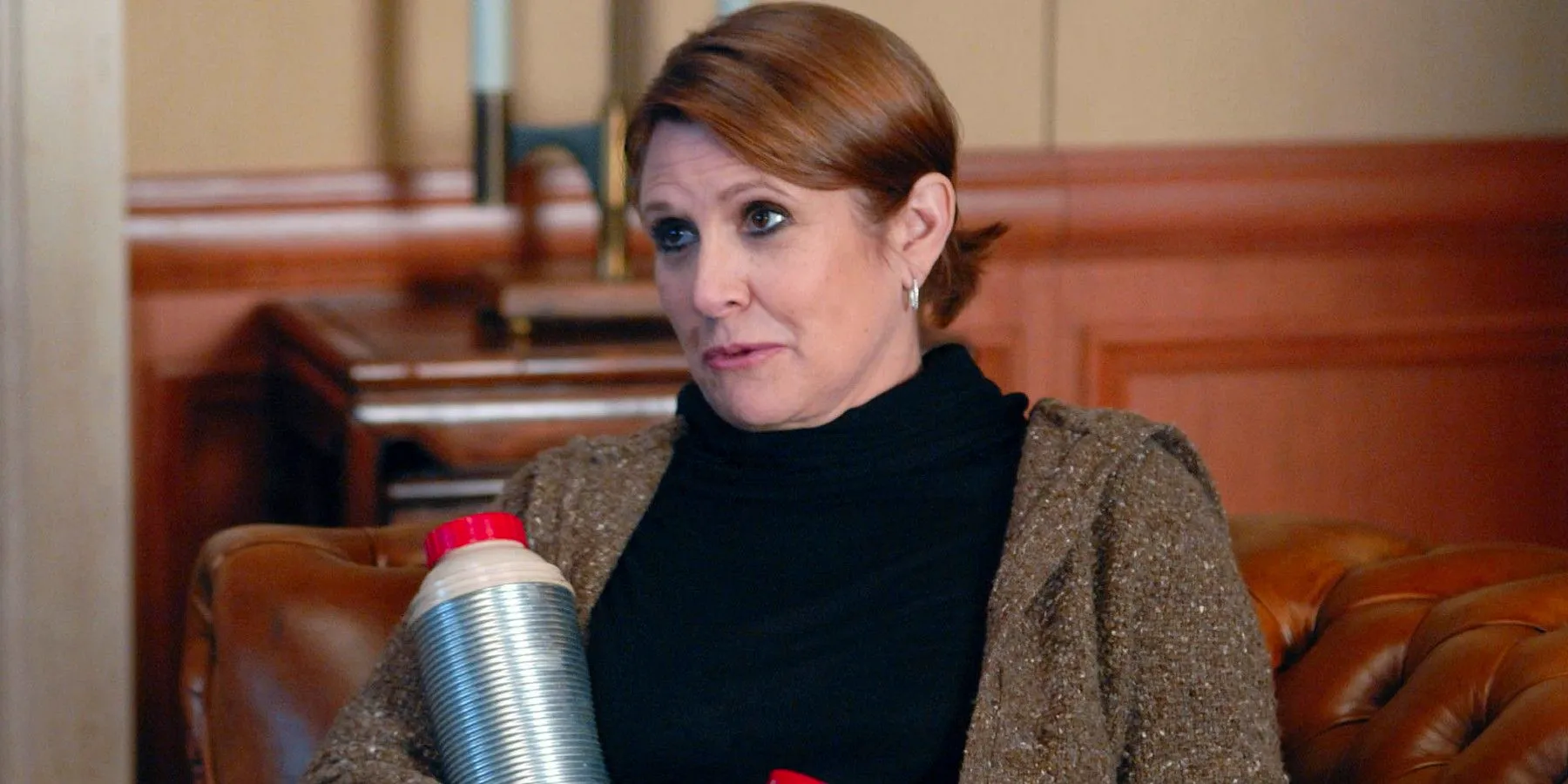 Carrie Fisher As Rosemary Howard stood in Jack Donaghy's office with a thermal cup In 30 Rock Image