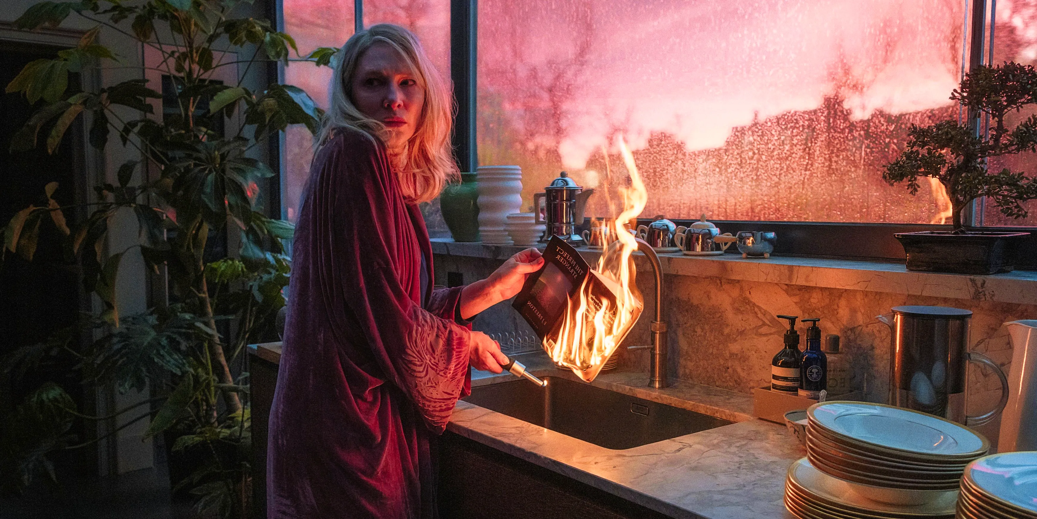 Cate Blanchett nervously holding a burning book over a sink in Disclaimer Image