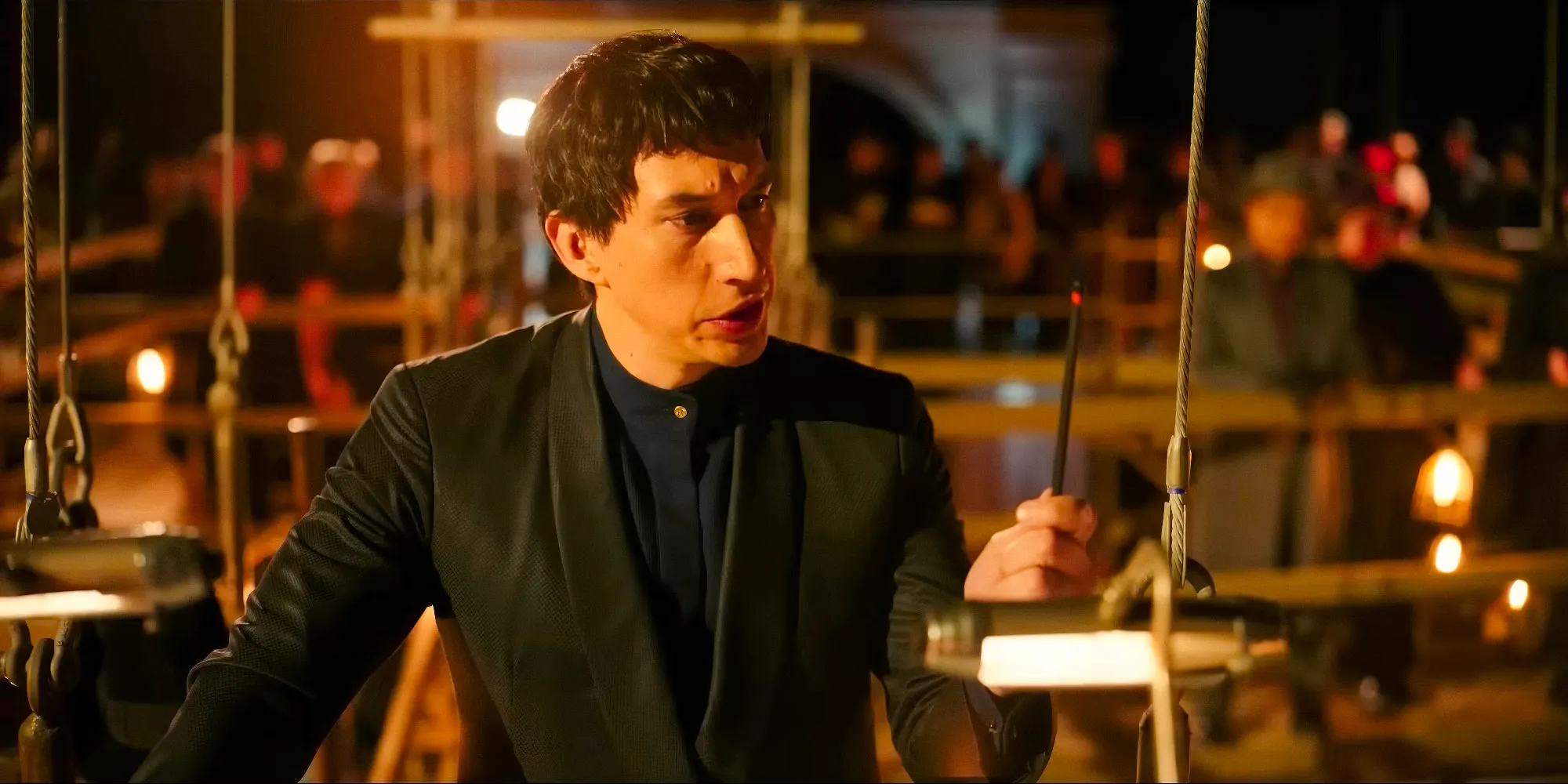 Cesar Catilina (Adam Driver) staring at what appears to be a magic wand in Megalopolis (2024) Image