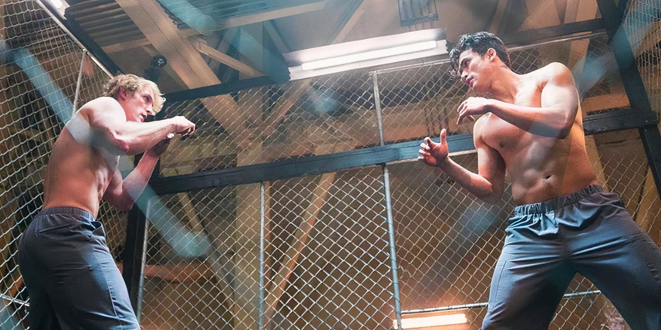 Charles Melton and Logan Paul in a shirtless cage fight in the Youtube movie The Thinning New World Order Image