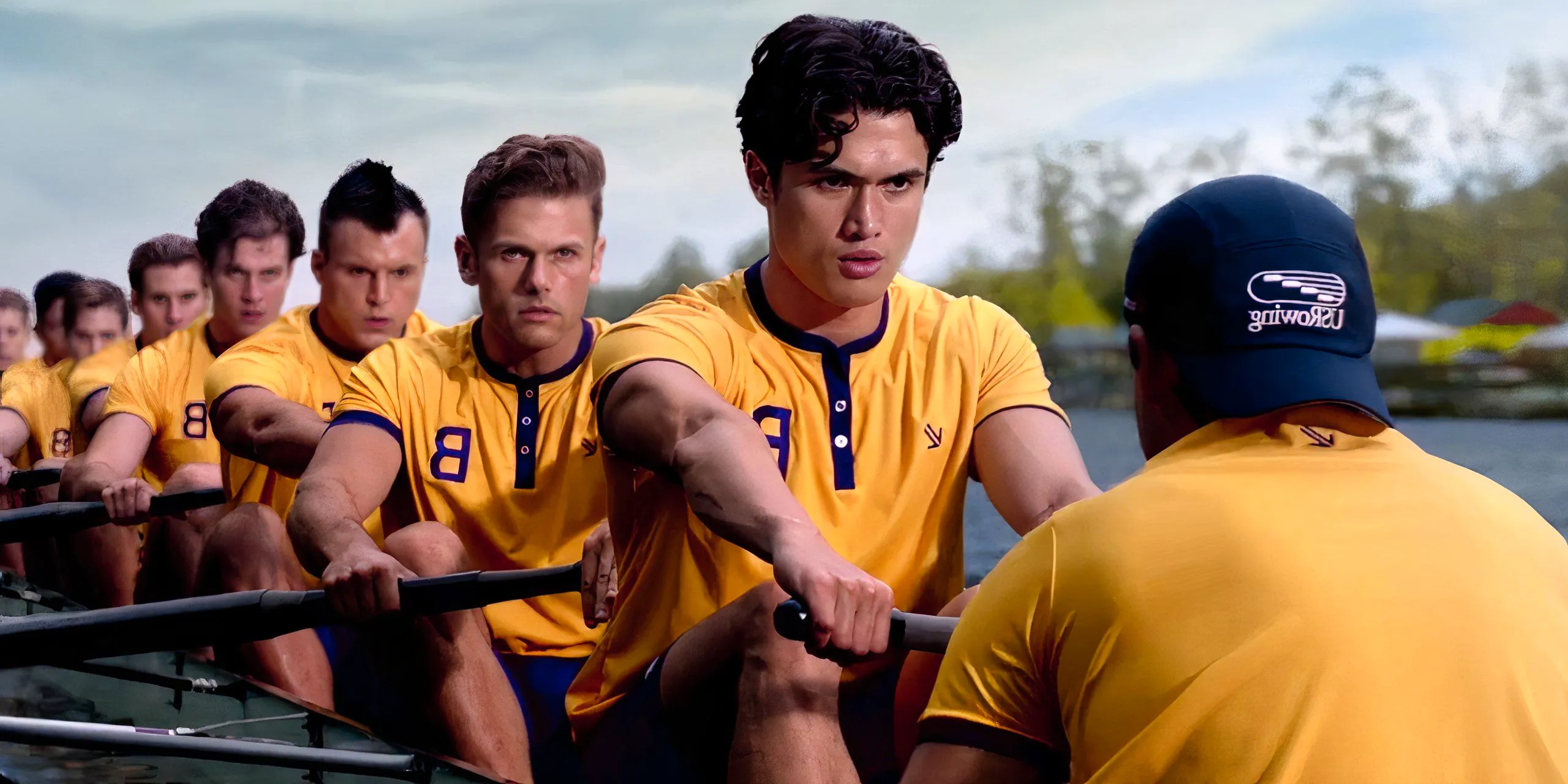 Charles Melton at the front of a boat of rowers in Heart of Champions Image