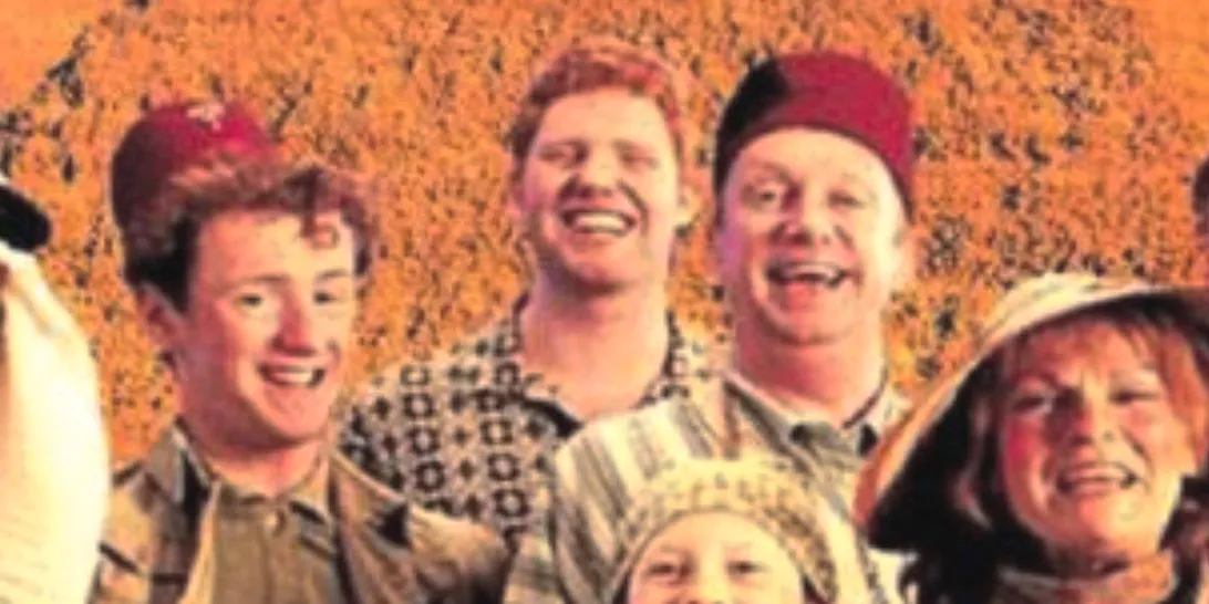 Charlie Weasley (Alex Crockford) smiles in a Weasley family photo. Image