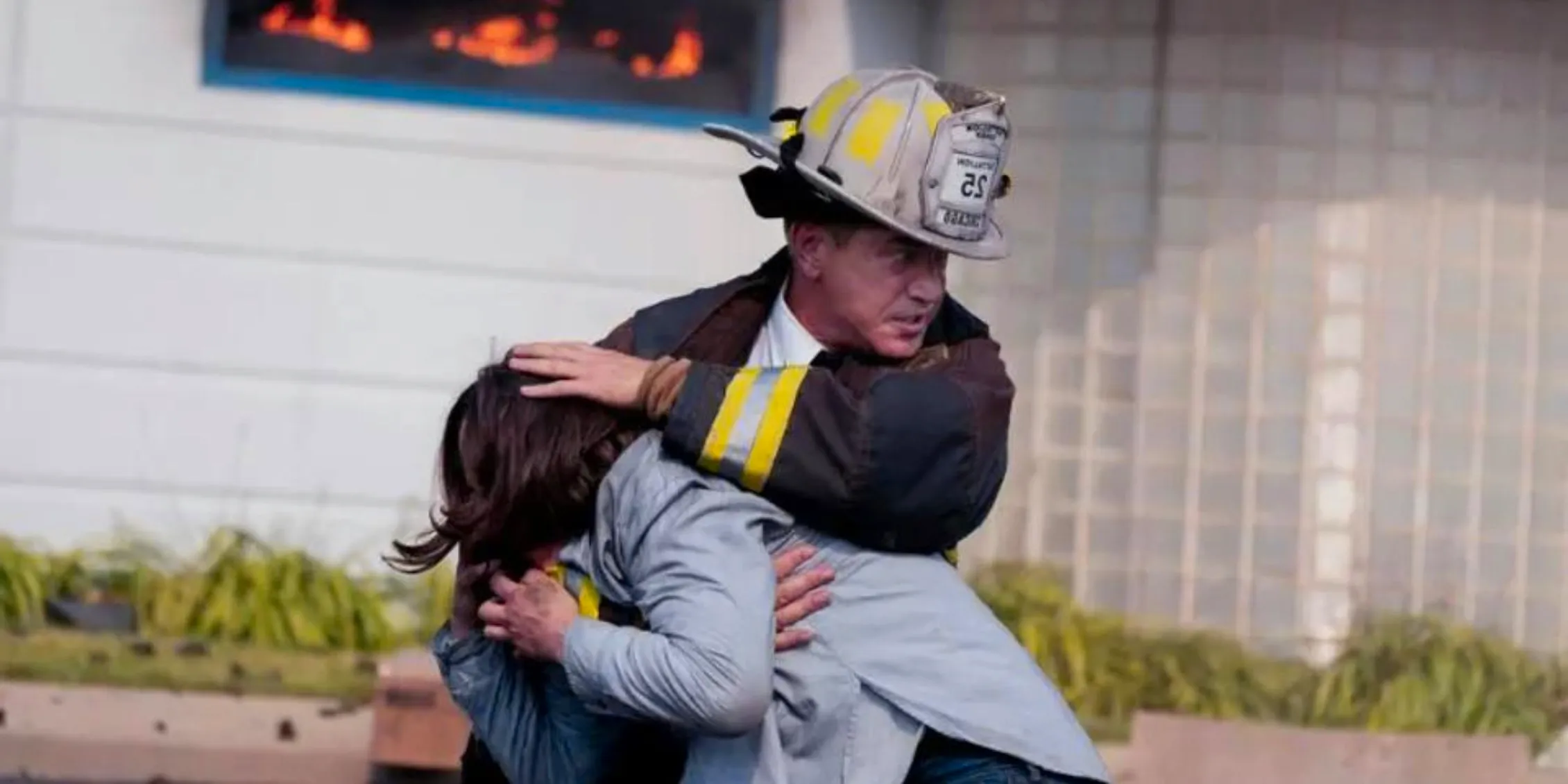 Chicago Fire Pascal carrying a young woman away from a fire Image