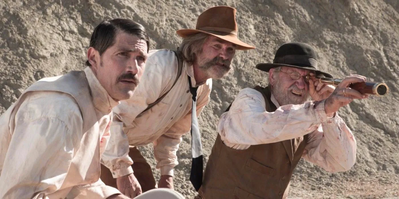 Chicory uses a spotting scope while Franklin and Brooder watch in Bone Tomahawk Image