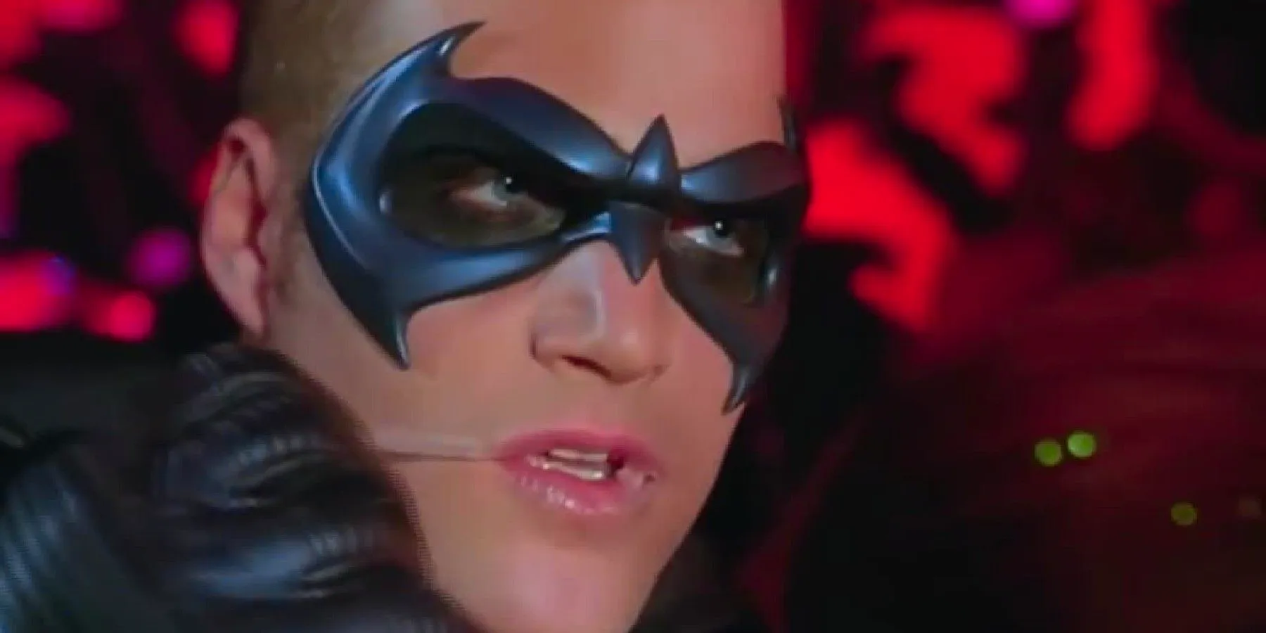 Chris O'Donnell's Robin removing wax lips from his lips in Batman & Robin Image