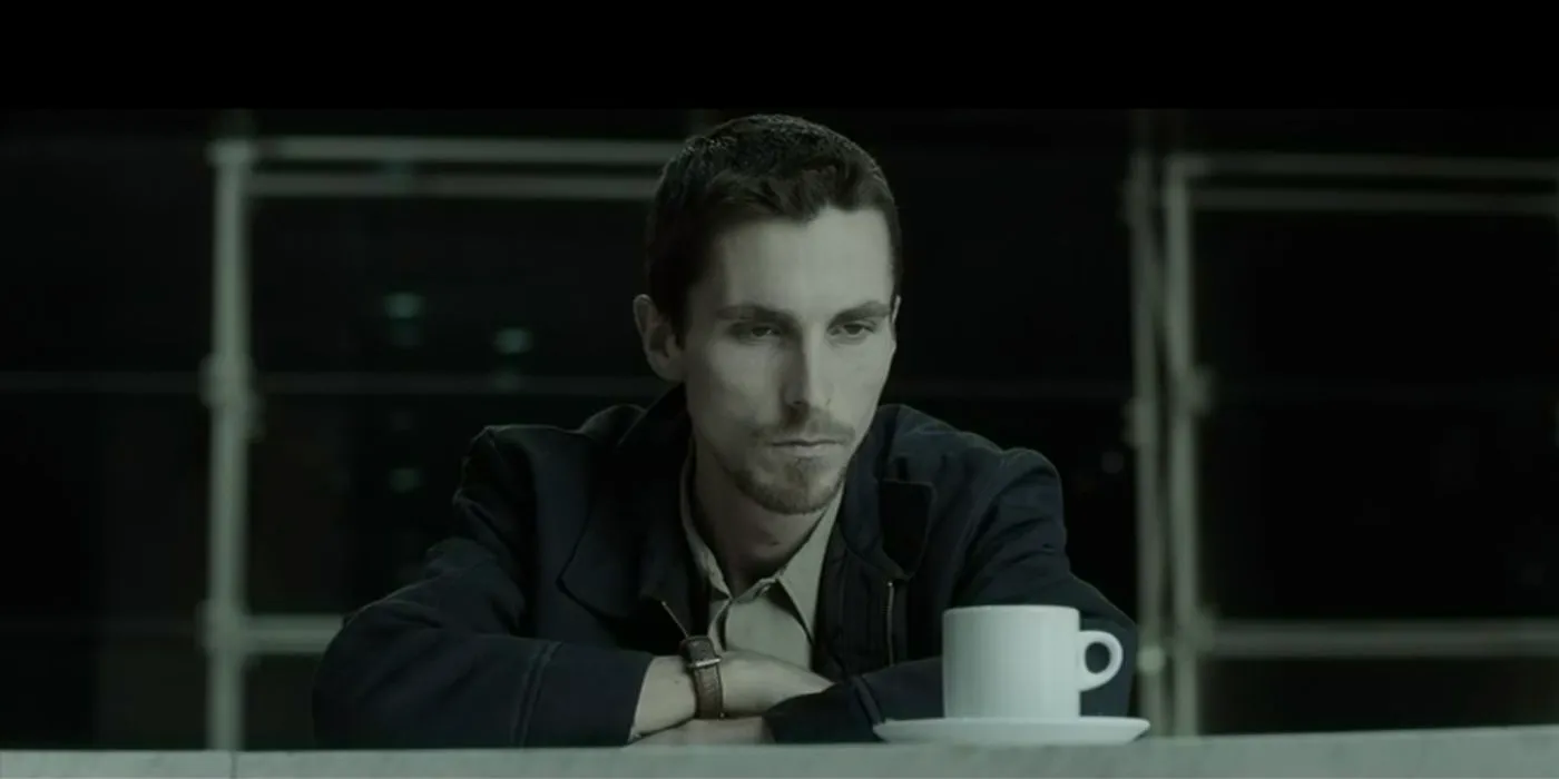 Christian Bale sitting in front of a cup in The Machinist Image