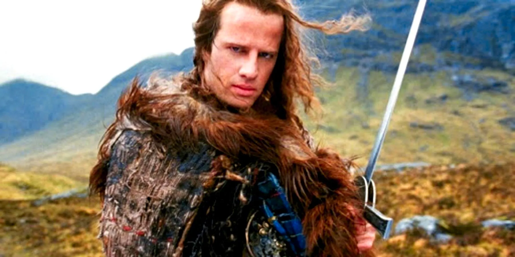 Christopher Lambert holding a sword on a mountain in Highlander. Image