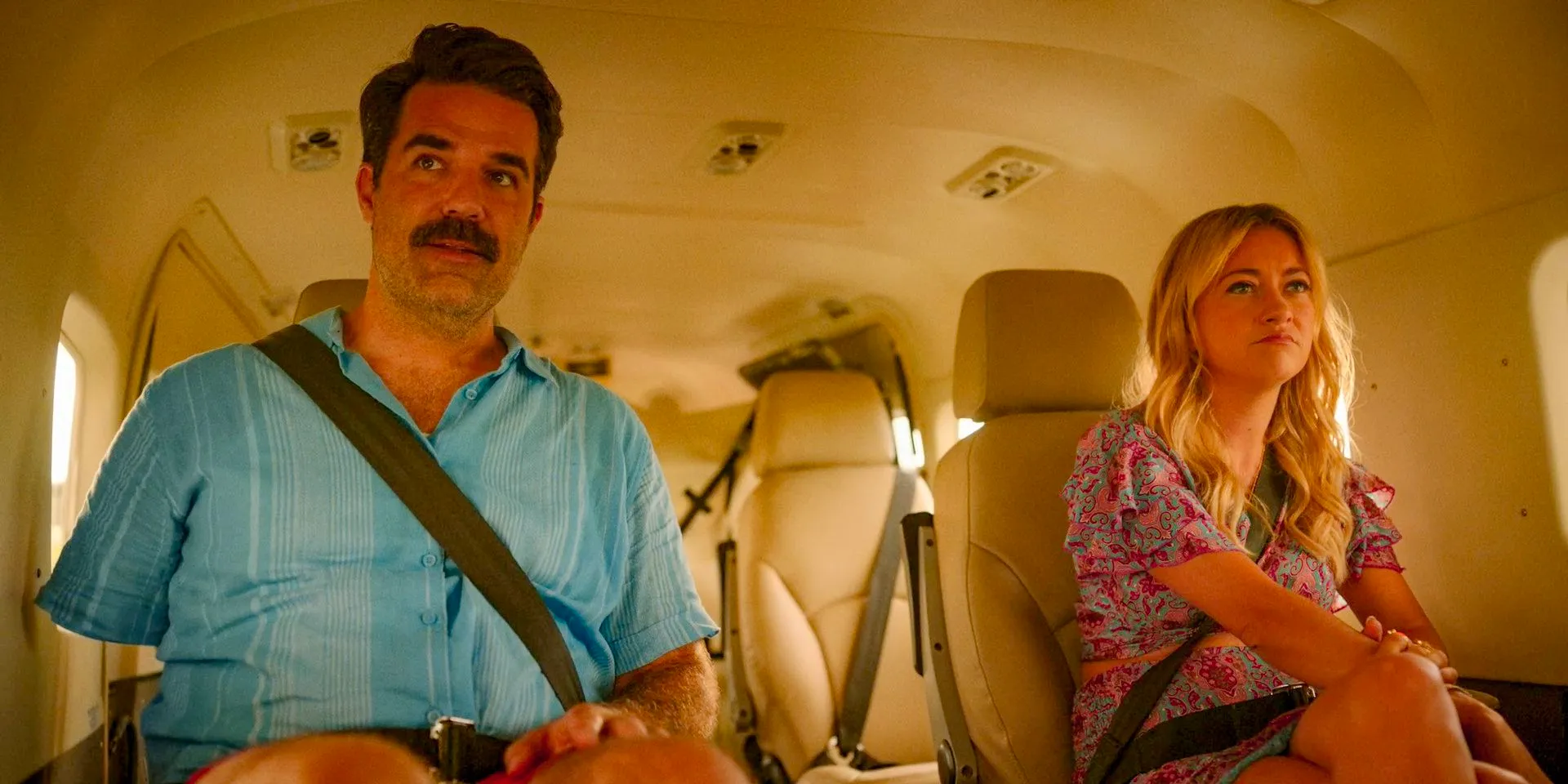 Christopher (Rob Delaney) and Eve (Meredith Hagner) escape Florida by plane in Bad Monkey Season 1 Episode 5 Image