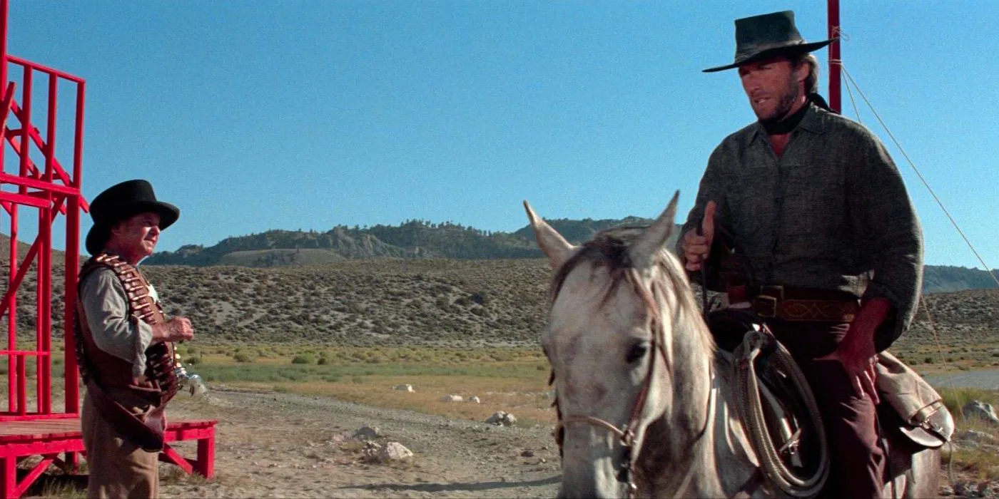 Clint Eastwood as The Stranger talks to another man while riding a horse in High Plains Drifter  Image