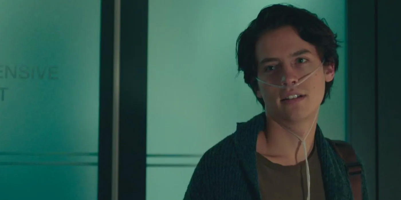 Cole Sprouse wearing a breathing tube and looking at someone offscreen in Five Feet Apart Image