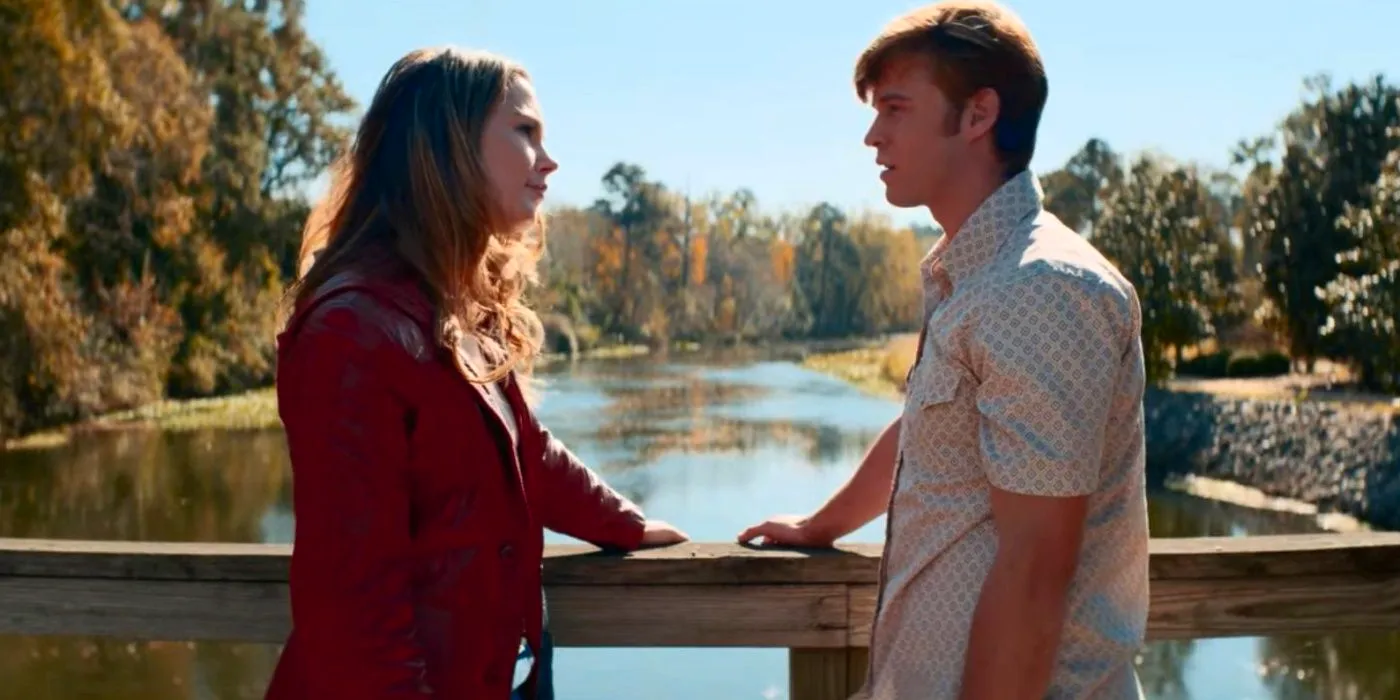 Colin Ford as Rickey Hill and Siena Bjornerud as Gracie Shanz looking at each other on a bridge in The Hill. Image