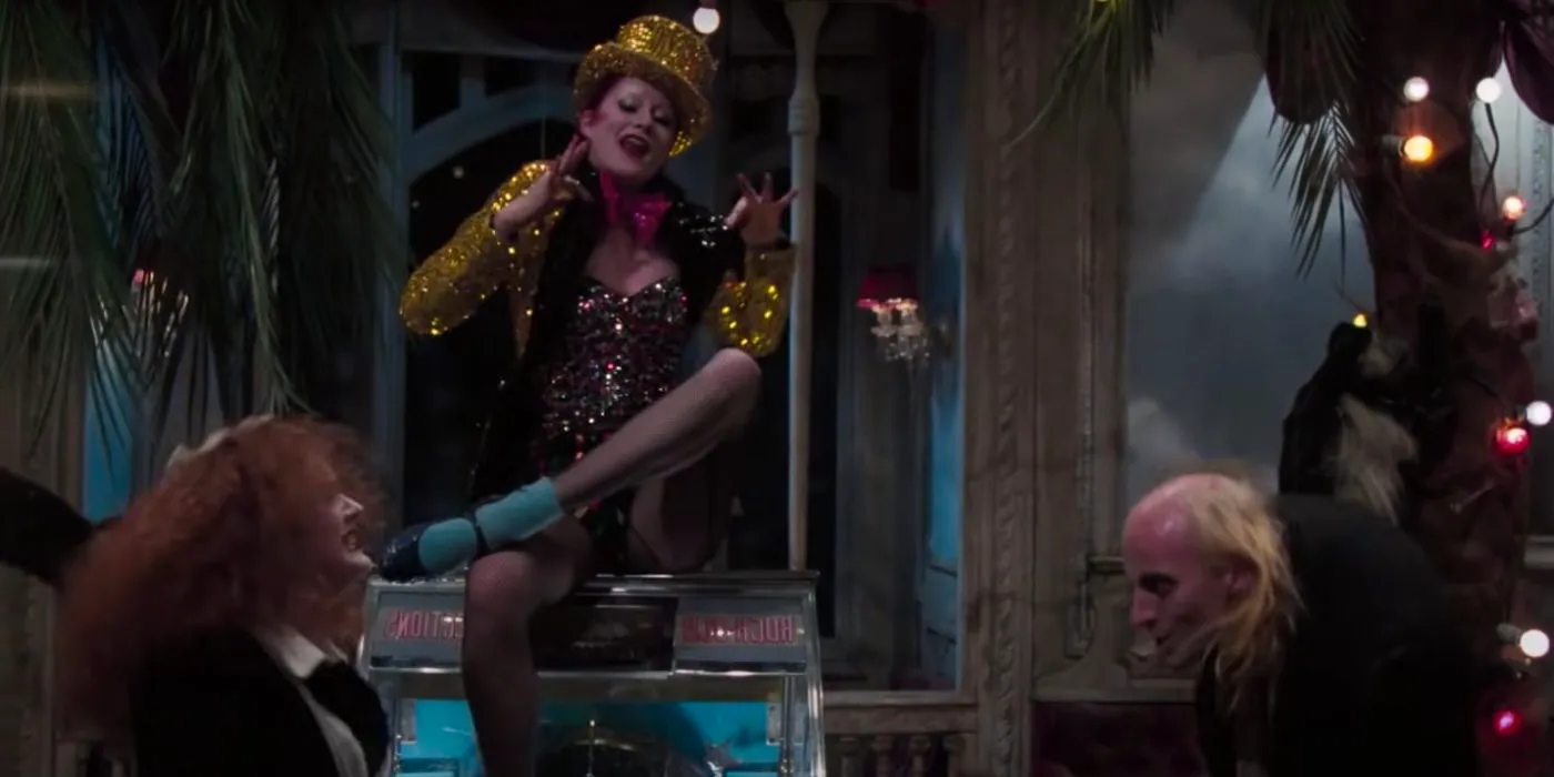 Columbia sitting up above Riff raff and Magenta in Rocky Horror Image