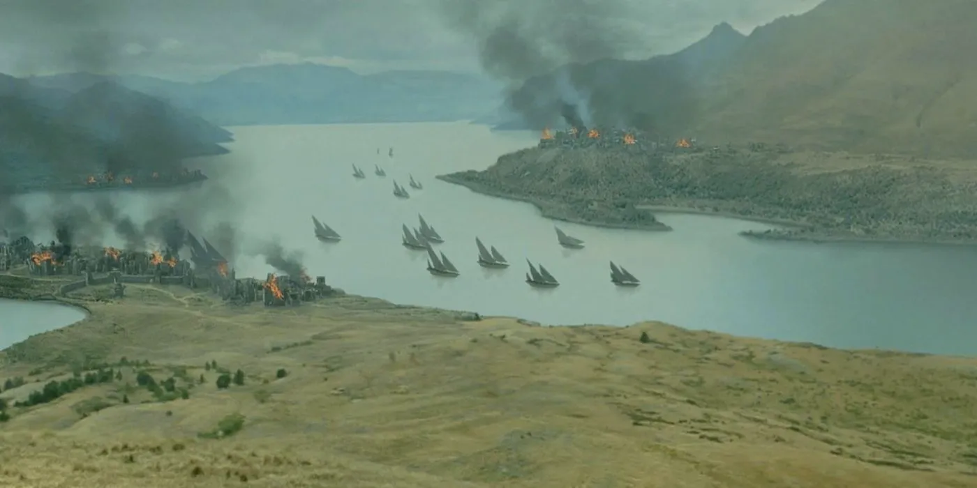 Corsair of Umber ships sailing up a river as Pelargir and other towns burn in the Extended Edition of The Return of the King. Image