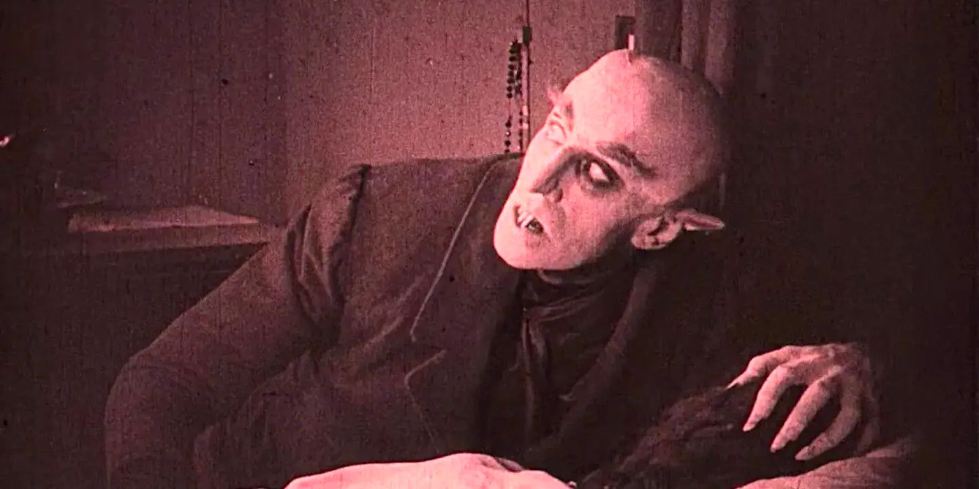 Count Orlok (Max Schreck) looming over his victim in the 1922 silent film Nosferatu Image