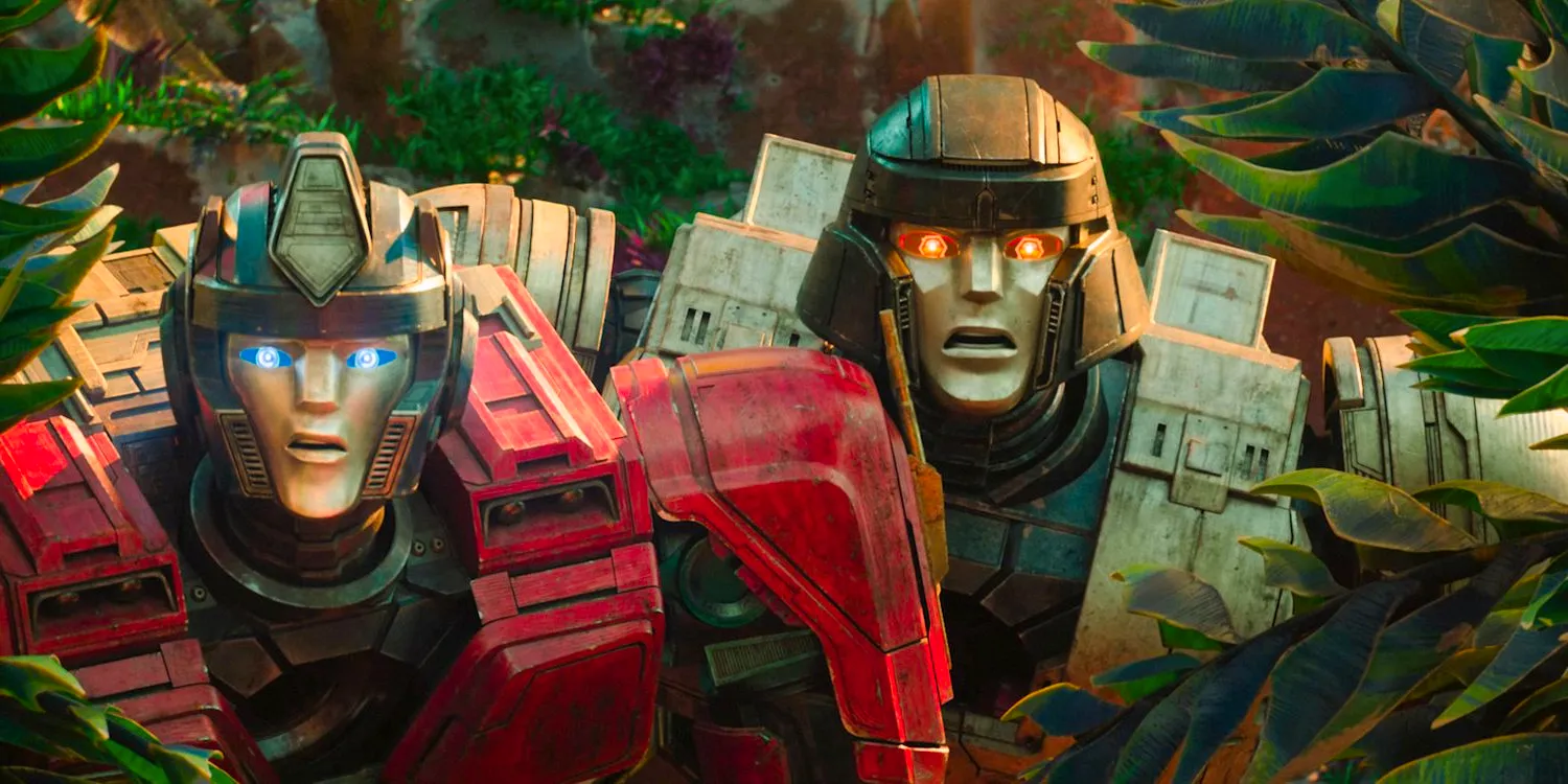 D-16 and Orion Pax, surprised, emerge from the vegetation in Transformers One. Image