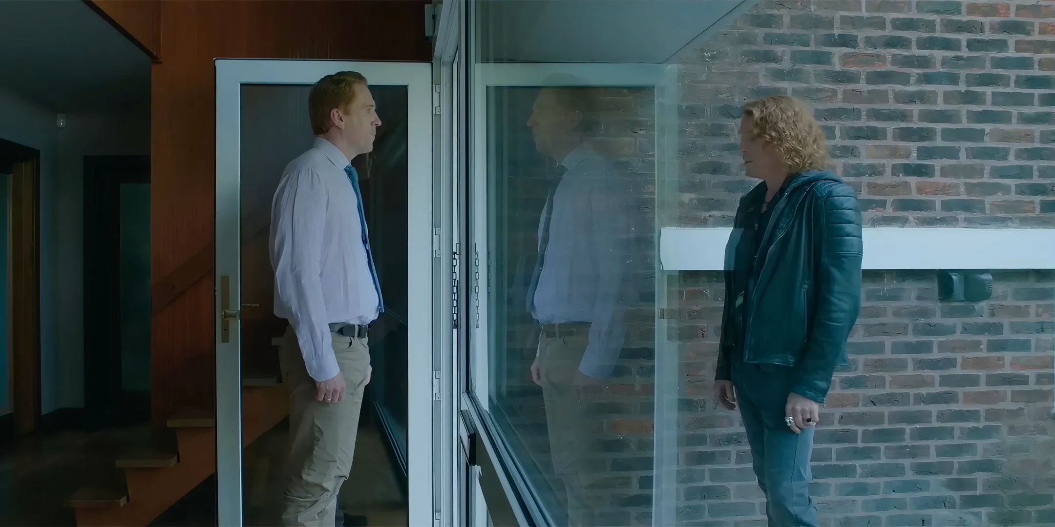 Damian Lewis as Peter and Will standing on opposite sides of the house's door in The Radleys Image