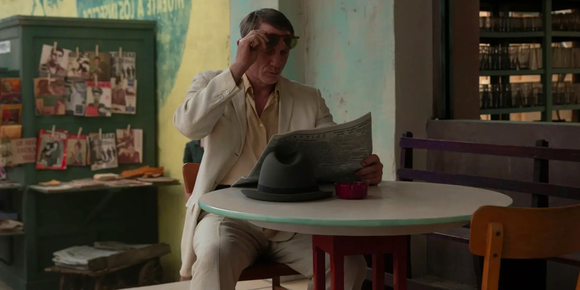 Daniel Craig reading a paper in Queer Image