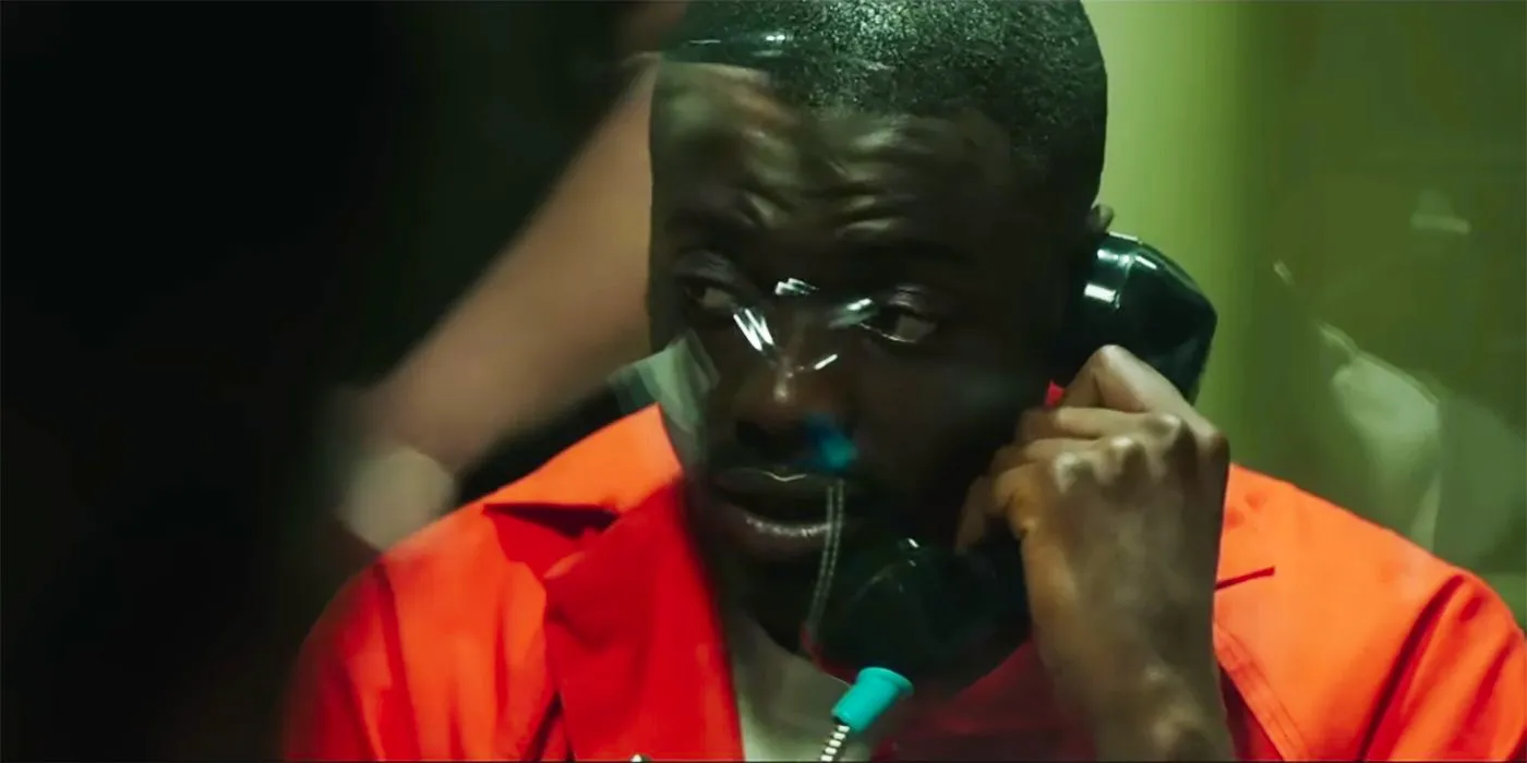 Daniel Kaluuya Chris in jail on the phone with an orange jumpsuit on in the Get Out alternate ending Image