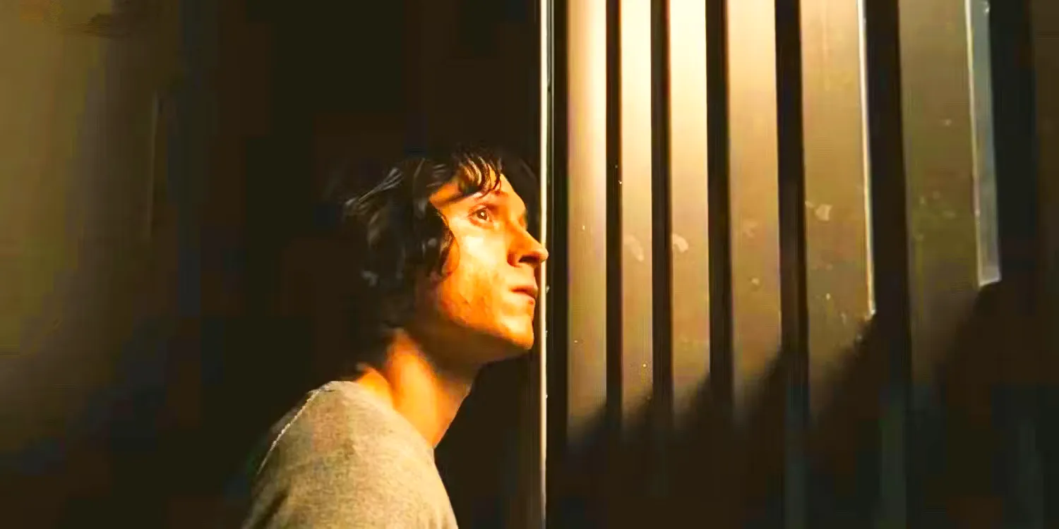 Danny (Tom Holland) looking through bars in The Crowded Room. Image