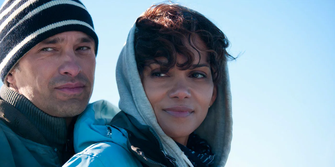 Dark Tide Halle Berry Halle Berry as Kate Mathieson and Olivier Martinez as Jeff Mathieson embrace with the sky in the background Image