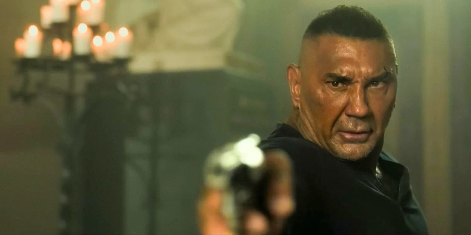 Dave Bautista as Joe Flood aiming a gun in The Killer's Game 2024 Image