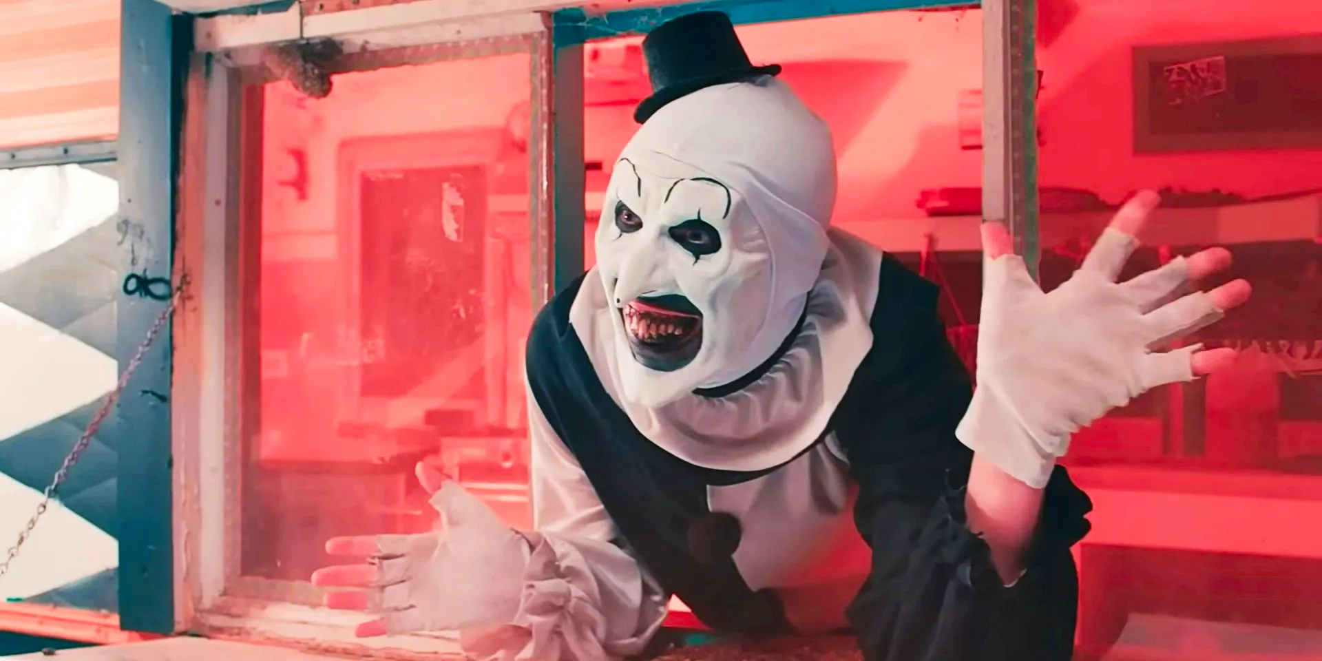 David Howard Thornton's Art the Clown in a window in Terrifier 2 Image