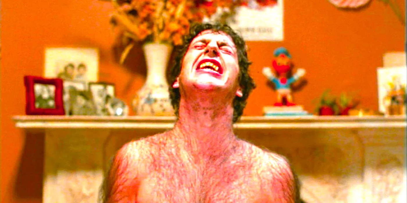 David Naughton grimaces with pain while werewolf hairs sprout on his body in An American Werewolf in London Image