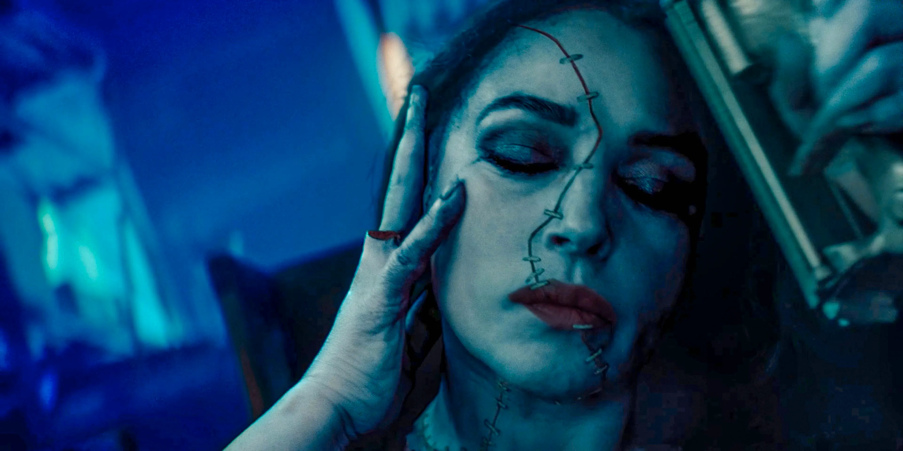 Delores (Monica Bellucci) with the skin of her face stapled in Beetlejuice Beetlejuice Image